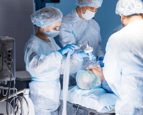 Patient in surgery with a team of surgeons