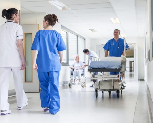 Health professionals walking down a hospital corridor