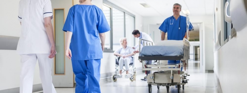 Health professionals walking down a hospital corridor