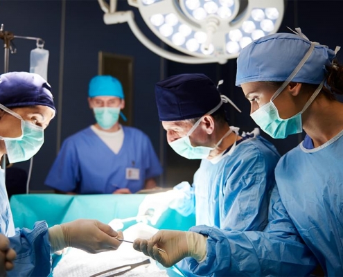 A surgeon and his team working together on a patient